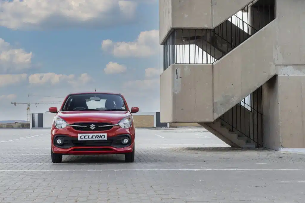 Red Suzuki Celerio next to a flight of stairs